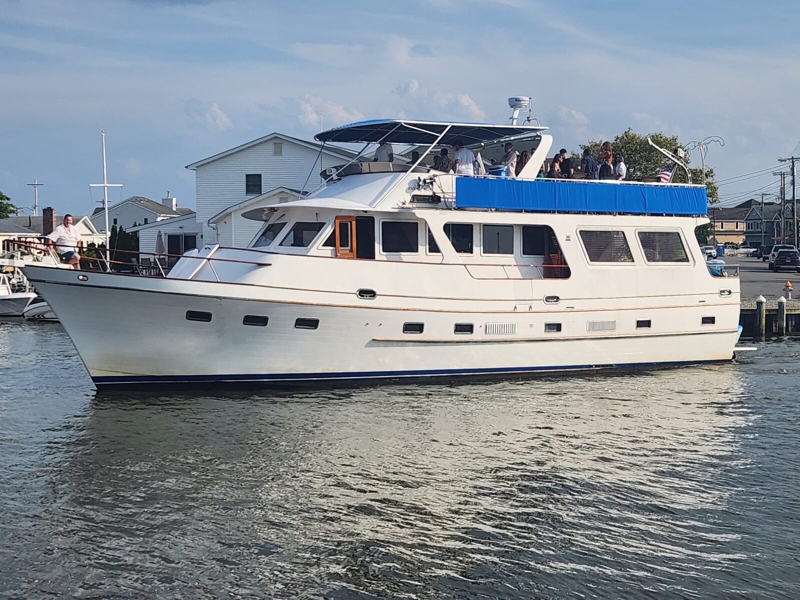 Guests on the upper deck of the yacht at the dock